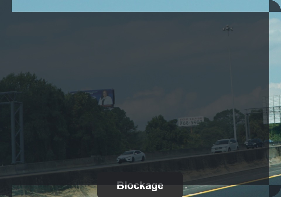 billboard blocked by trees